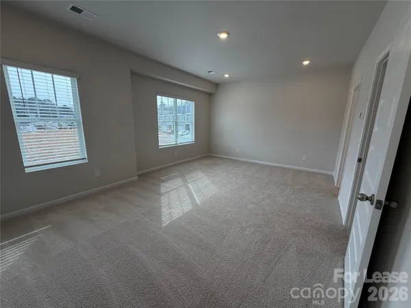 a view of an empty room and a window