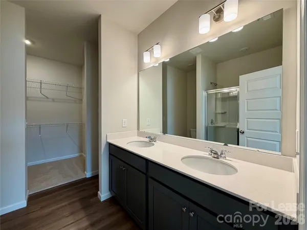 a bathroom with a double vanity sink and mirror