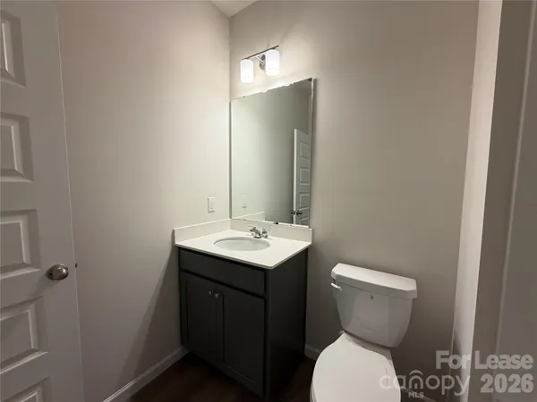 a bathroom with a sink toilet and mirror