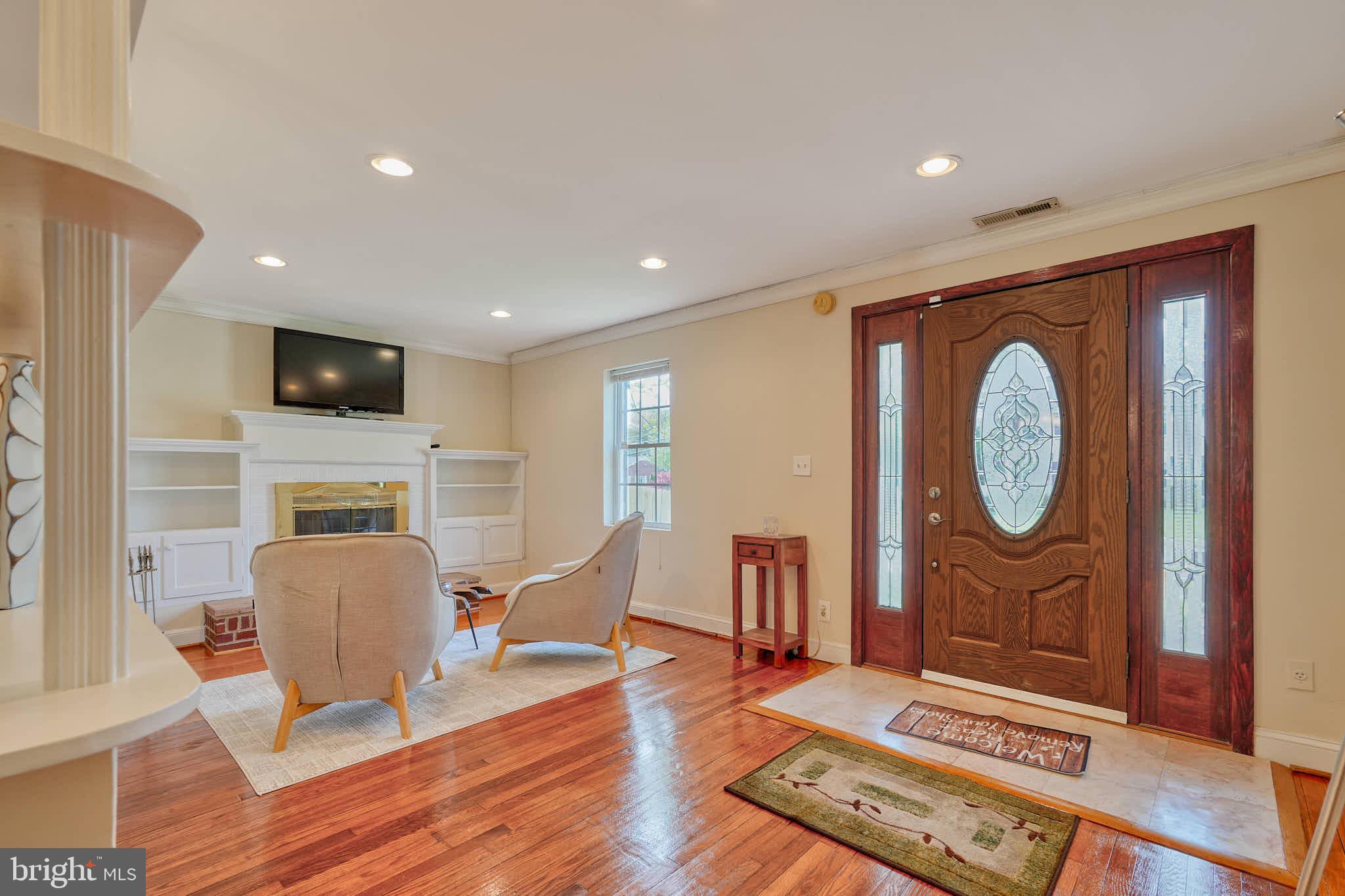 3318 Memorial Street Alexandria, VA 22306 - Photo 2 of 49 a living room with furniture a fireplace and a flat screen tv