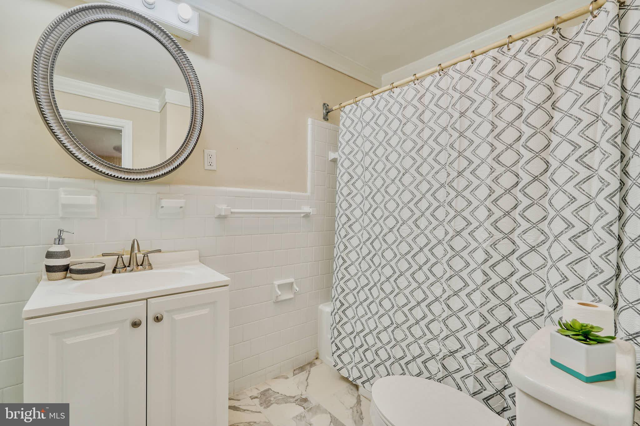3318 Memorial Street Alexandria, VA 22306 - Photo 24 of 49 a bathroom with a sink a mirror and a toilet