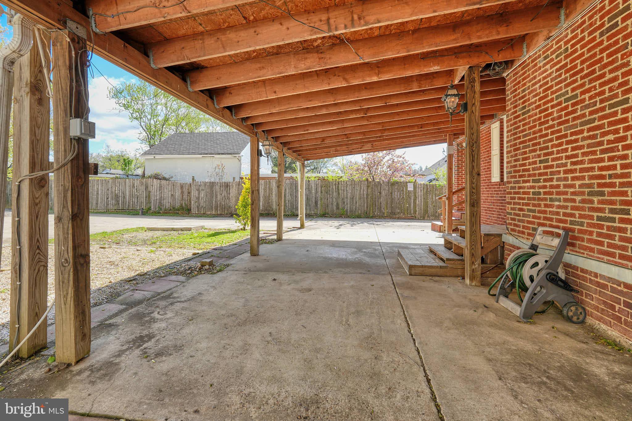 3318 Memorial Street Alexandria, VA 22306 - Photo 33 of 49 a view of a backyard with table and chairs and wooden fence