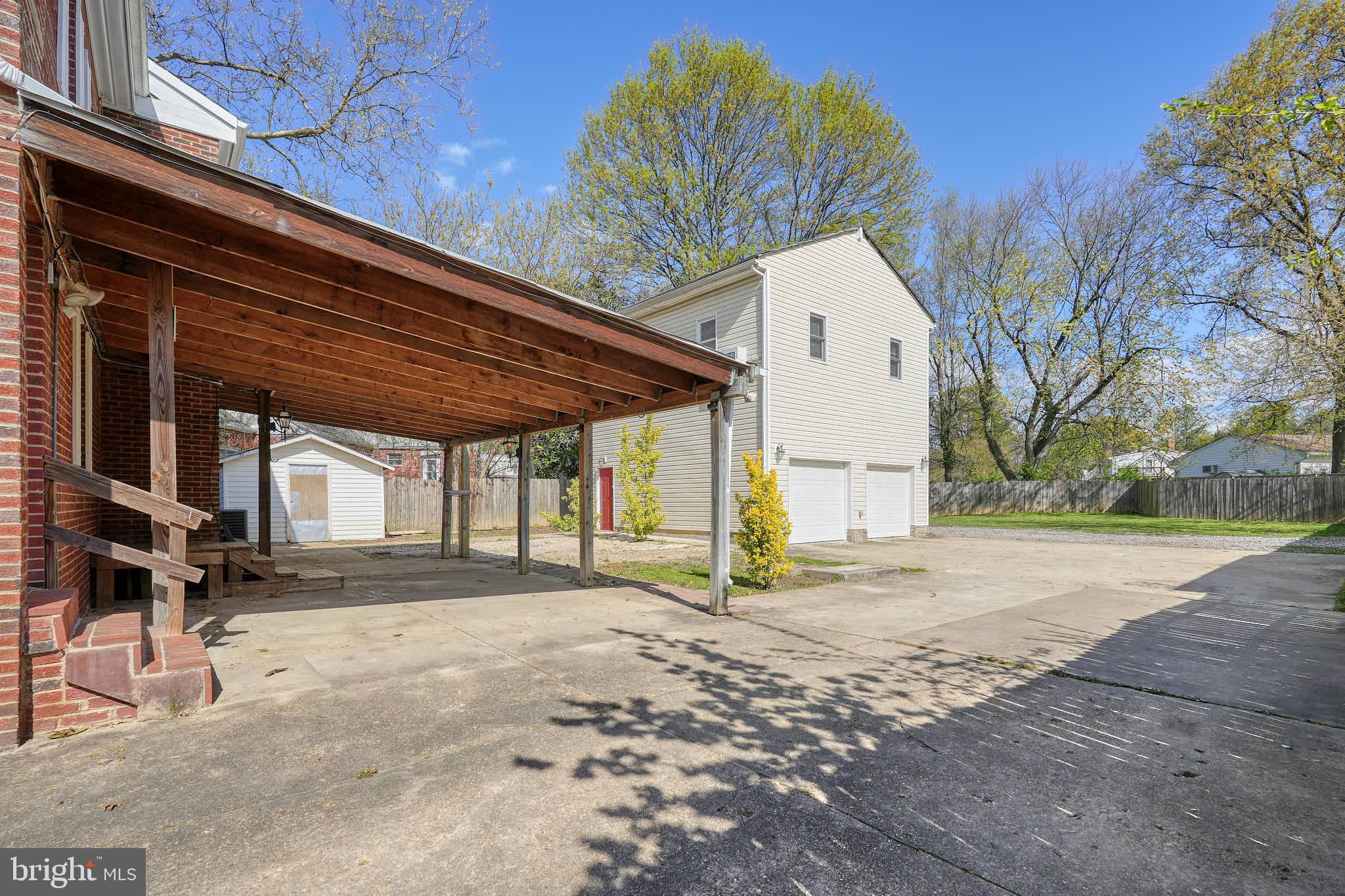 3318 Memorial Street Alexandria, VA 22306 - Photo 34 of 49 a backyard of a house with large trees and outdoor seating