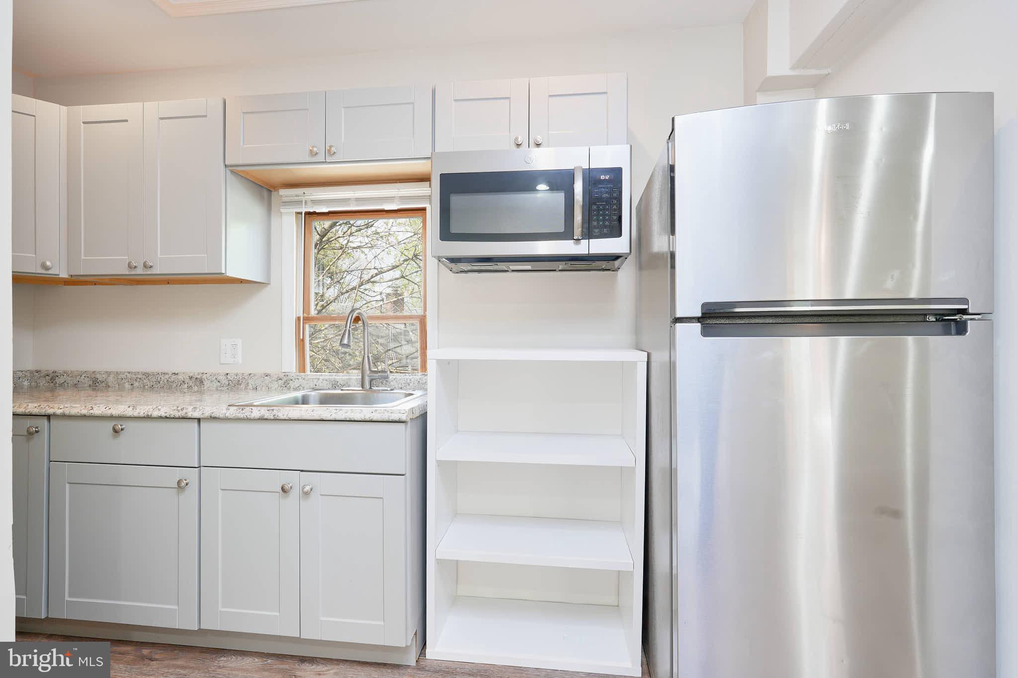 3318 Memorial Street Alexandria, VA 22306 - Photo 39 of 49 a white refrigerator freezer sitting inside of a kitchen