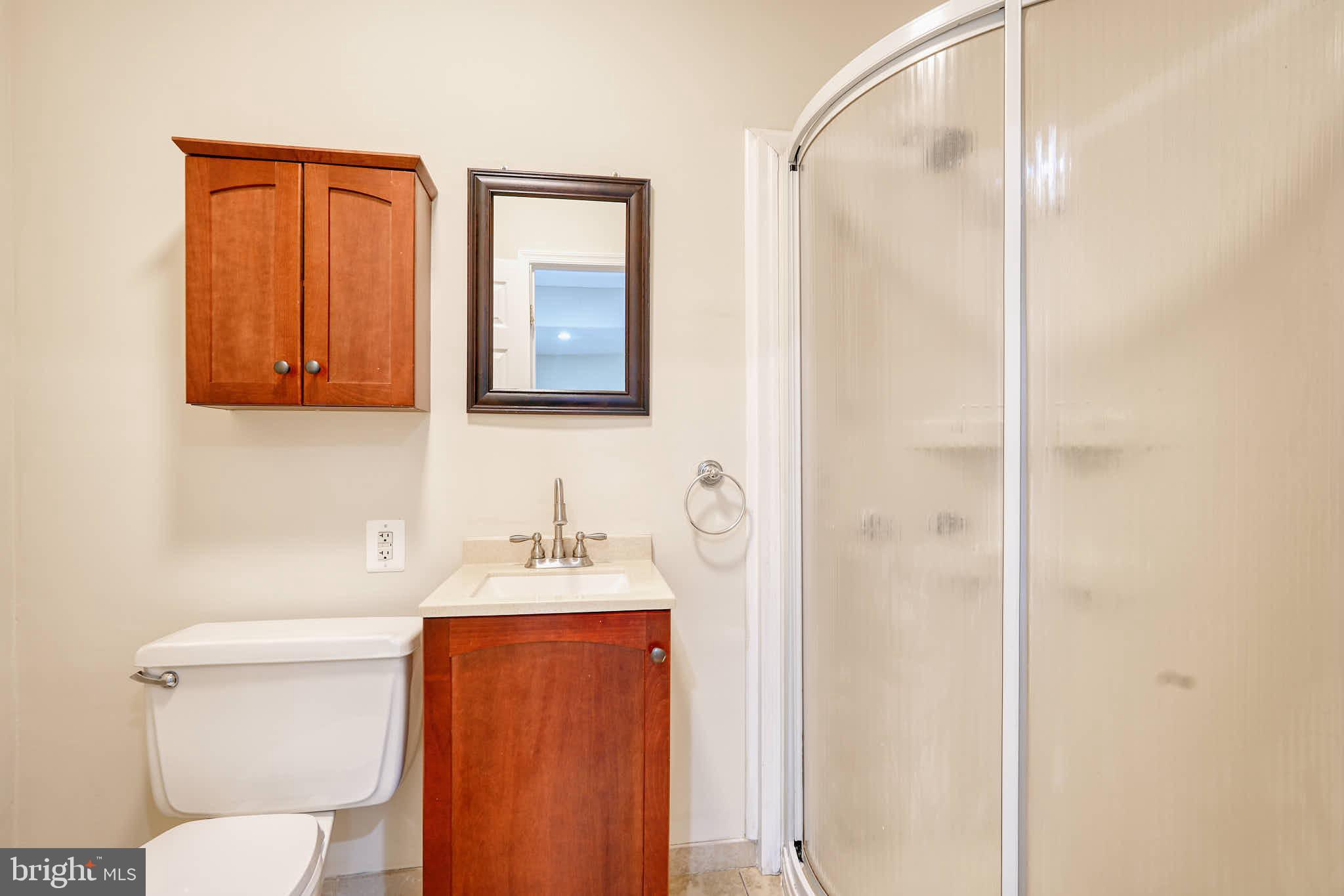 3318 Memorial Street Alexandria, VA 22306 - Photo 40 of 49 a bathroom with a toilet sink vanity and mirror