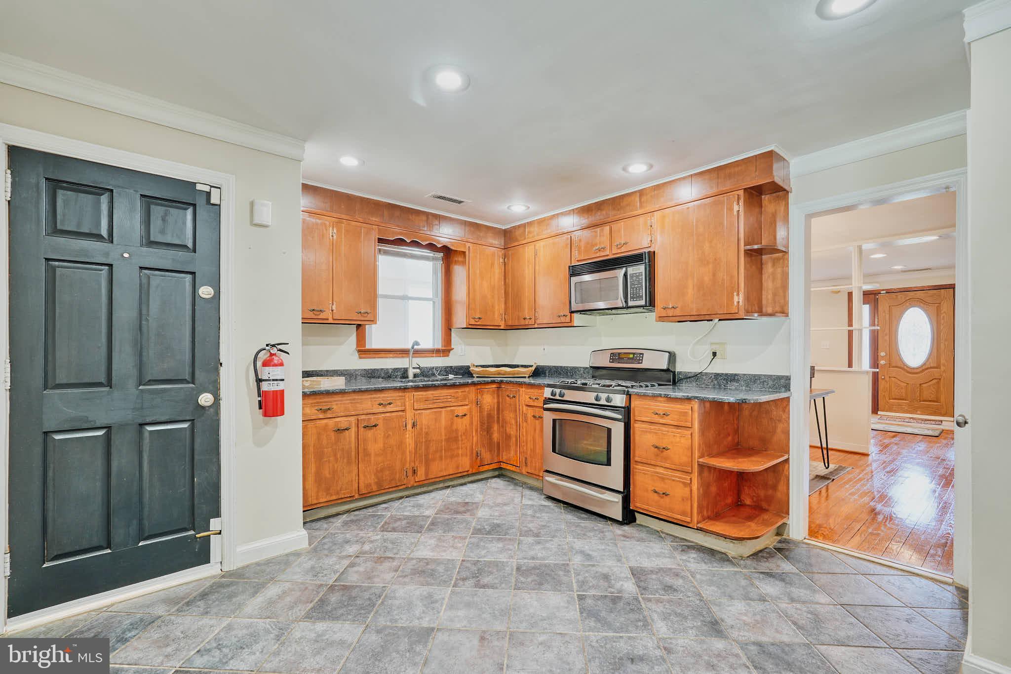 3318 Memorial Street Alexandria, VA 22306 - Photo 7 of 49 a large kitchen with stainless steel appliances granite countertop a stove a sink and dishwasher