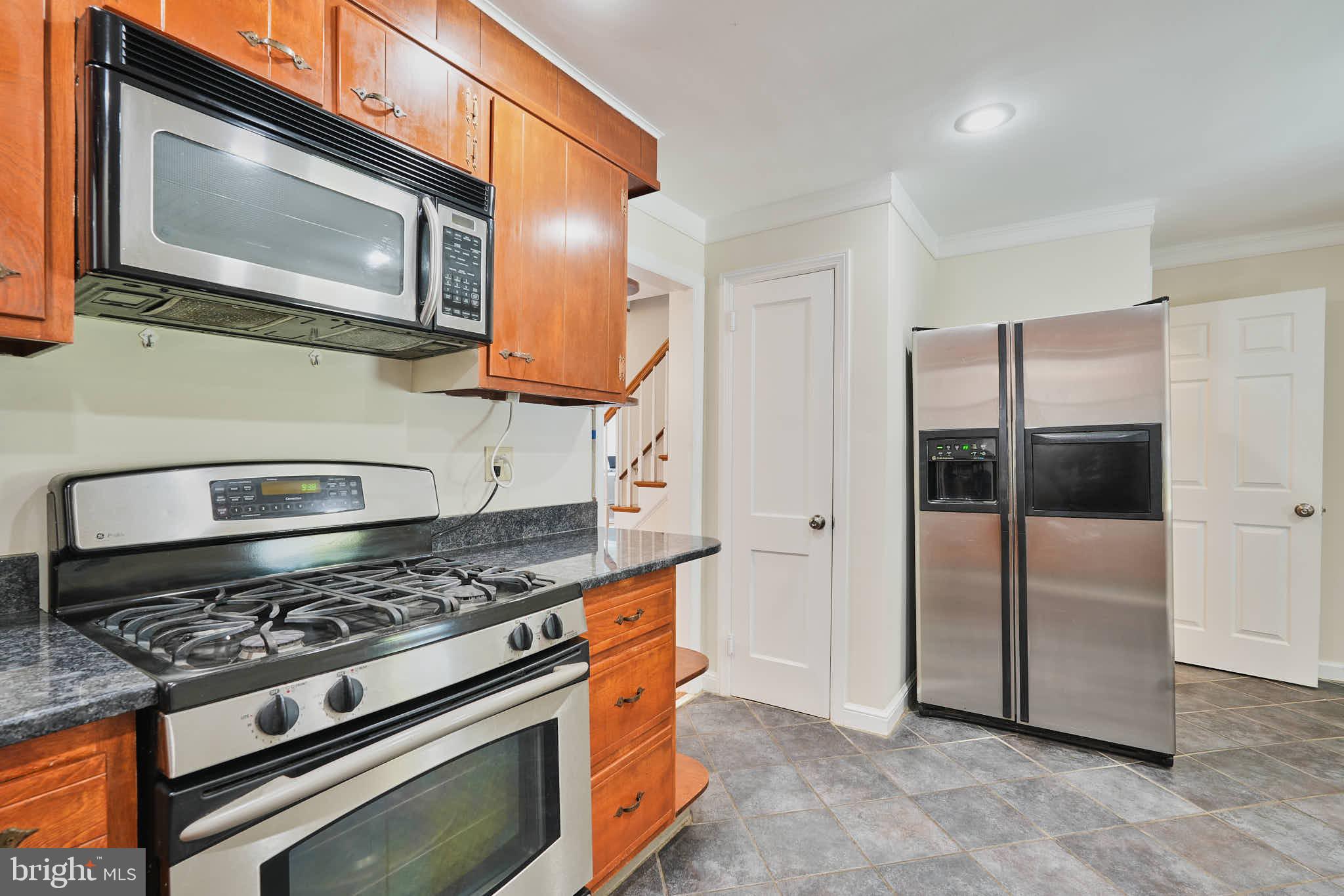 3318 Memorial Street Alexandria, VA 22306 - Photo 8 of 49 a kitchen with stainless steel appliances granite countertop a stove a microwave and a refrigerator