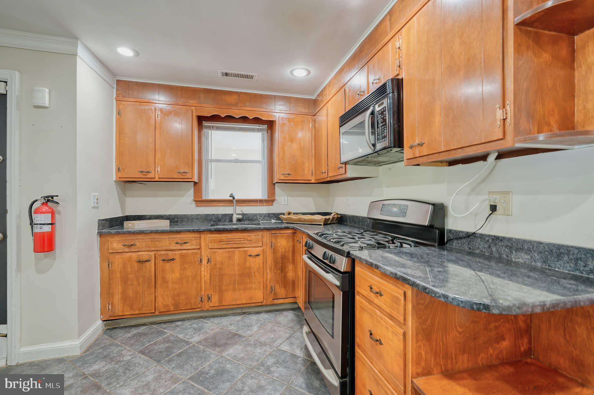 3318 Memorial Street Alexandria, VA 22306 - Photo 9 of 49 a kitchen with stainless steel appliances granite countertop a sink stove and cabinets
