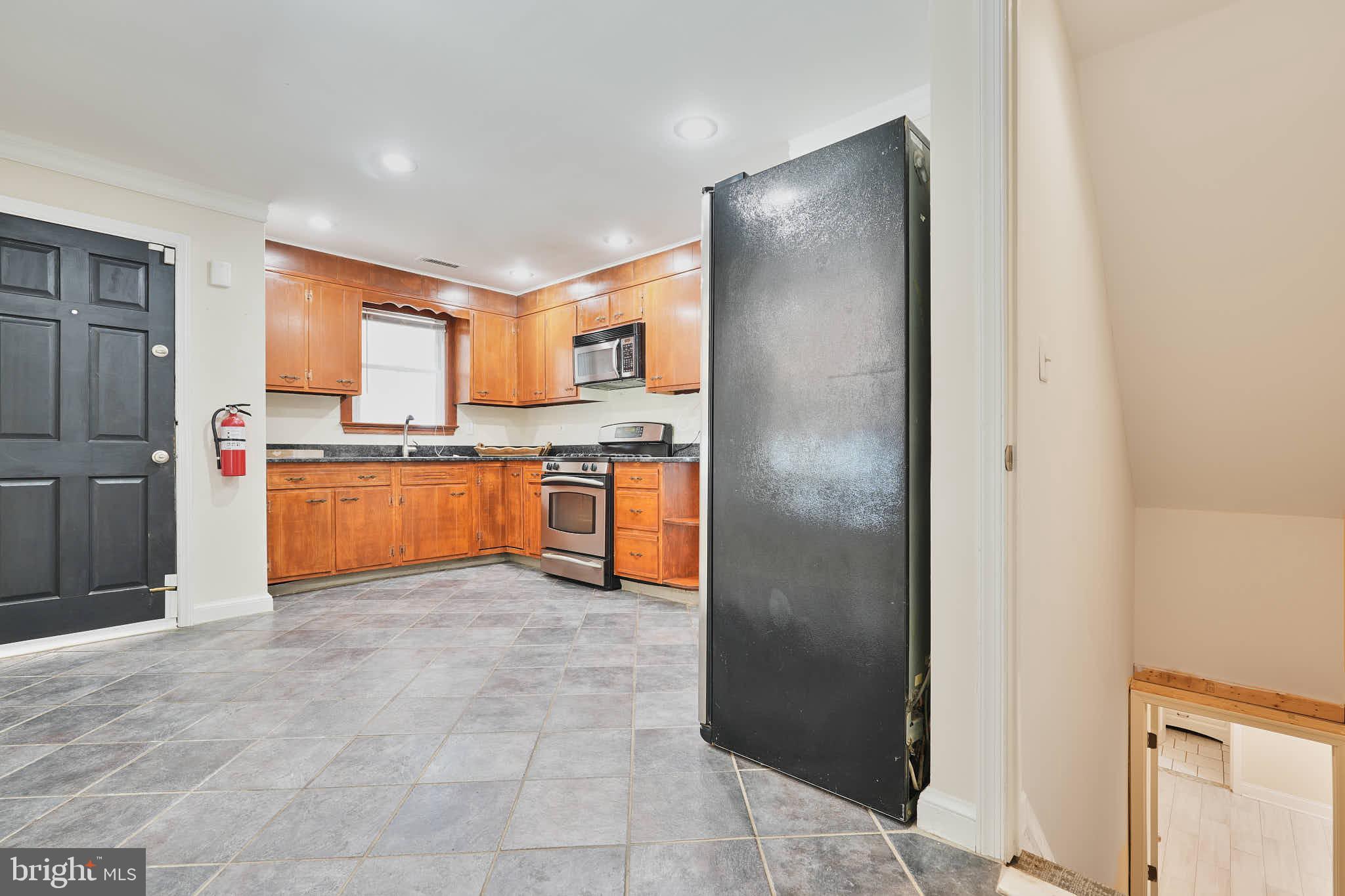 3318 Memorial Street Alexandria, VA 22306 - Photo 10 of 49 a kitchen with stainless steel appliances granite countertop a refrigerator and a sink