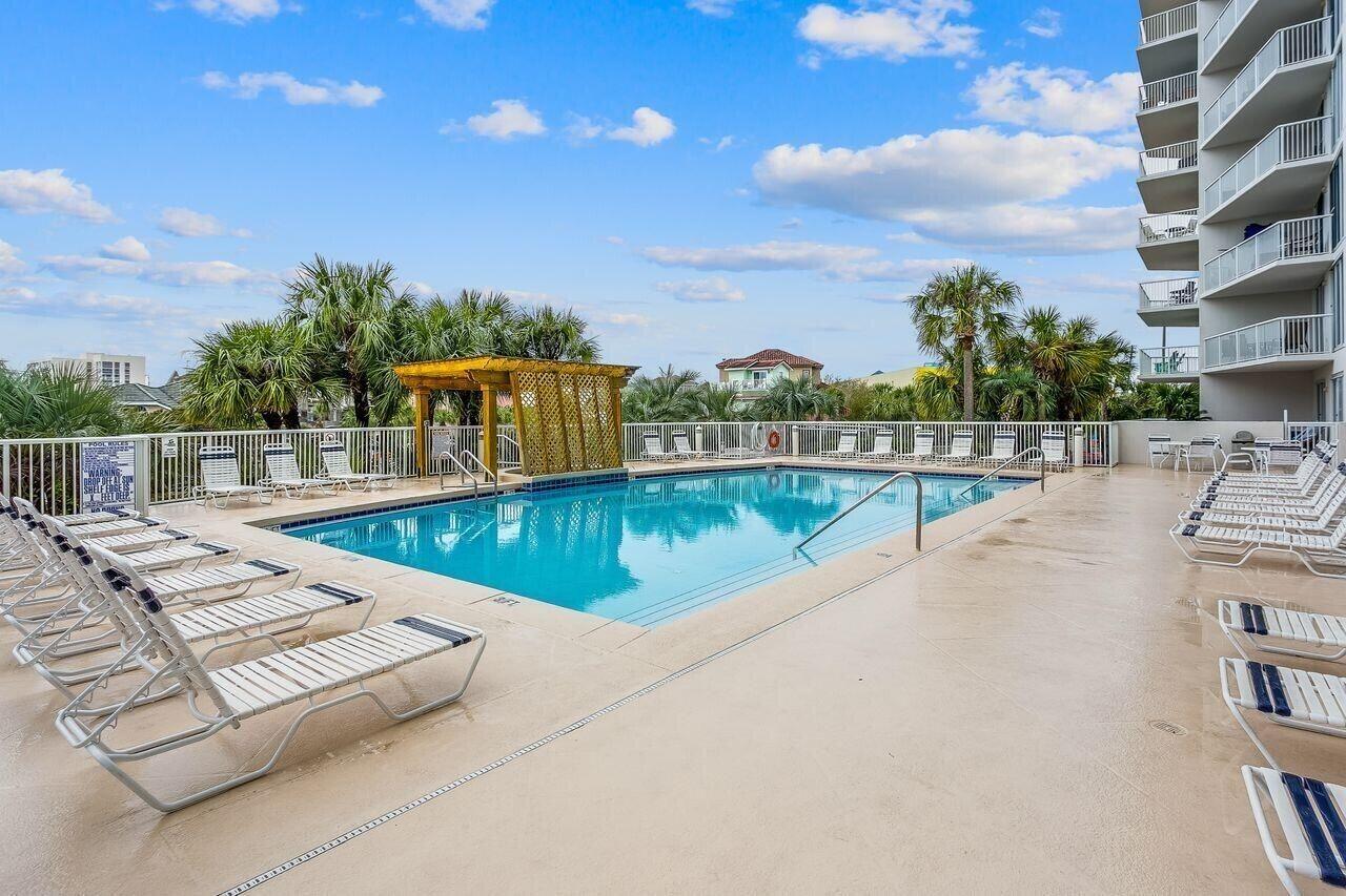 970 Highway 98, Unit 303 Destin, FL 32541 - Photo 8 of 42 a view of a swimming pool with a lounge chair