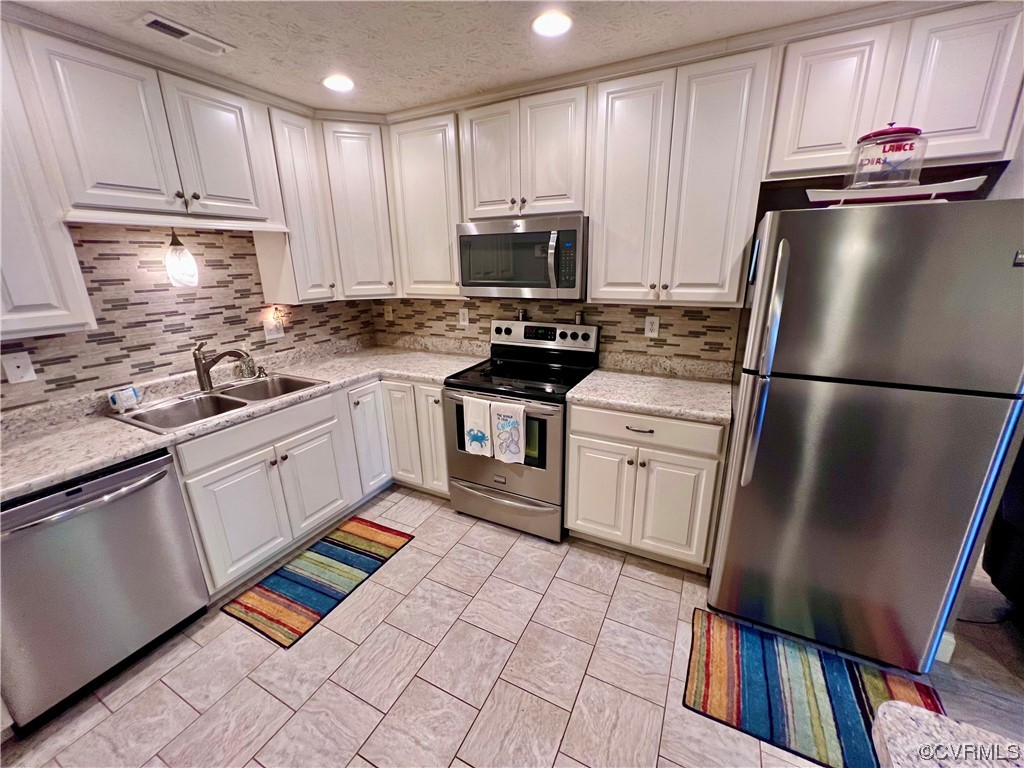 142 Circle Drive Deltaville, VA 23043 - Photo 19 of 49 a kitchen with a sink stainless steel appliances and cabinets