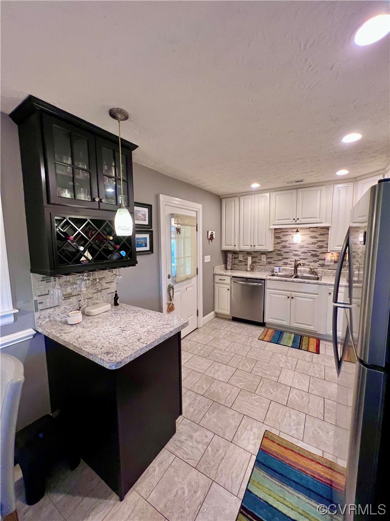 142 Circle Drive Deltaville, VA 23043 - Photo 20 of 49 a kitchen with stainless steel appliances kitchen island granite countertop a sink stove and refrigerator