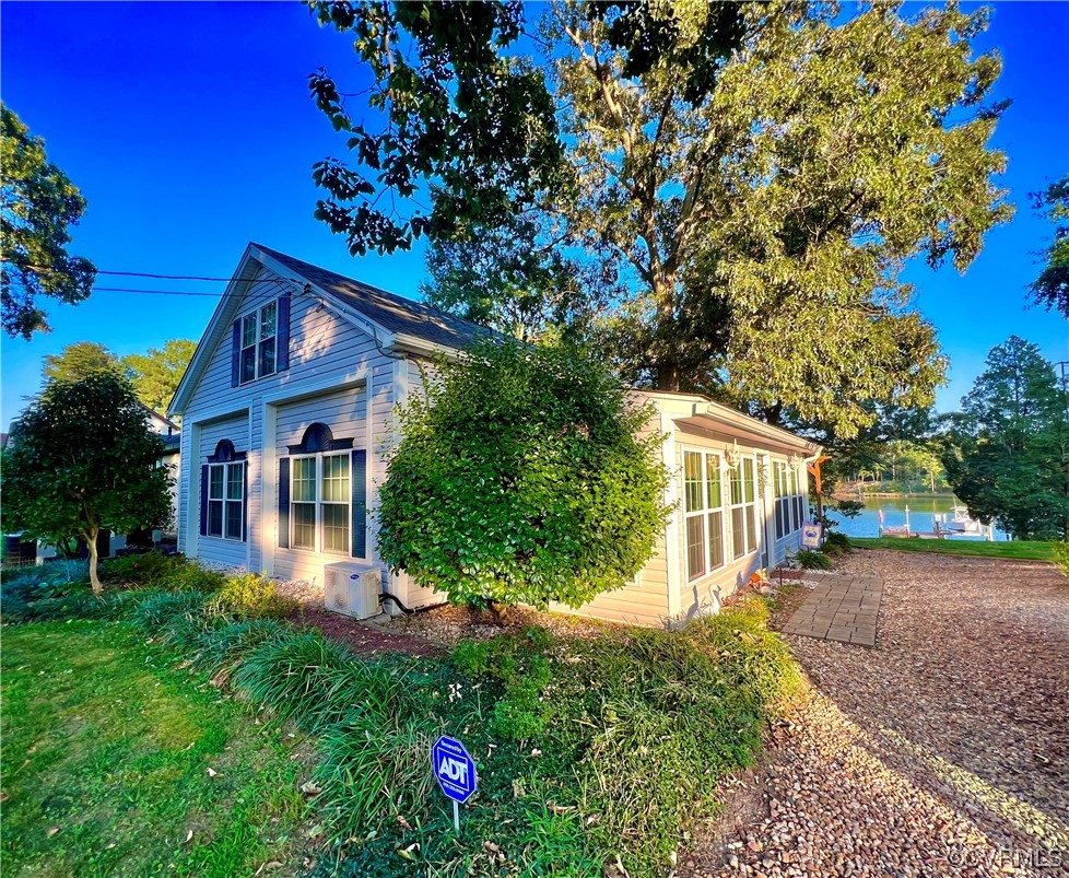 142 Circle Drive Deltaville, VA 23043 - Photo 2 of 49 a front view of a house with garden