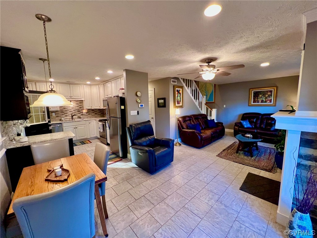 142 Circle Drive Deltaville, VA 23043 - Photo 21 of 49 a living room with furniture a flat screen tv and kitchen view