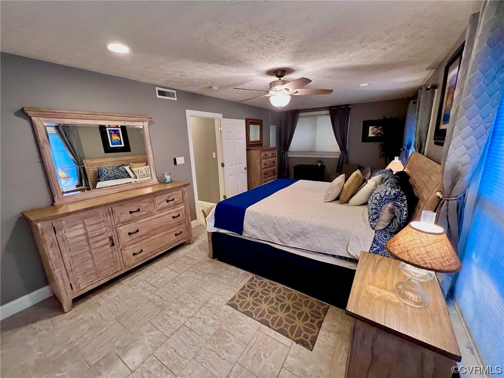 142 Circle Drive Deltaville, VA 23043 - Photo 30 of 49 a bedroom with a large bed and a dresser