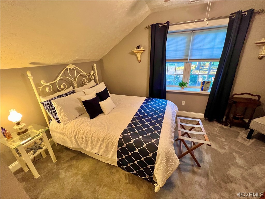 142 Circle Drive Deltaville, VA 23043 - Photo 37 of 49 a bedroom with a bed and wooden floor