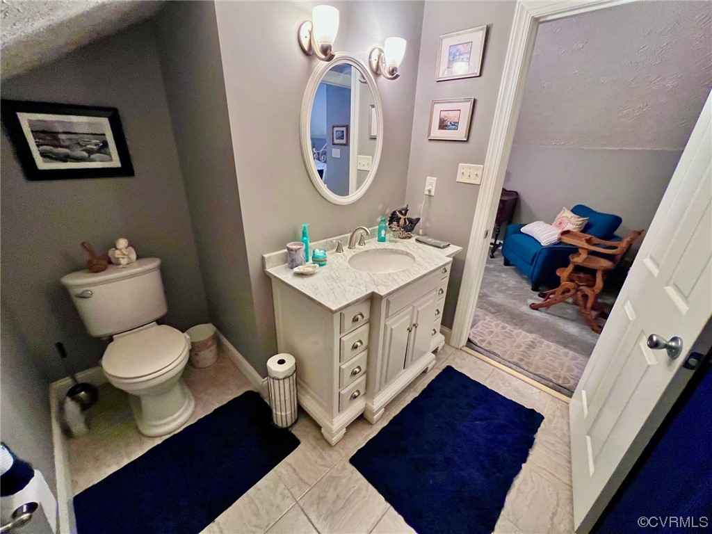 142 Circle Drive Deltaville, VA 23043 - Photo 44 of 49 a bathroom with a toilet a sink and a mirror