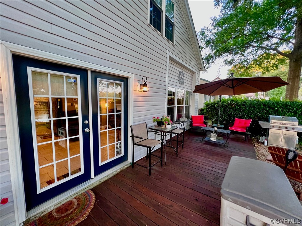 142 Circle Drive Deltaville, VA 23043 - Photo 5 of 49 a view of a patio with table and chairs potted plants with wooden floor and fence