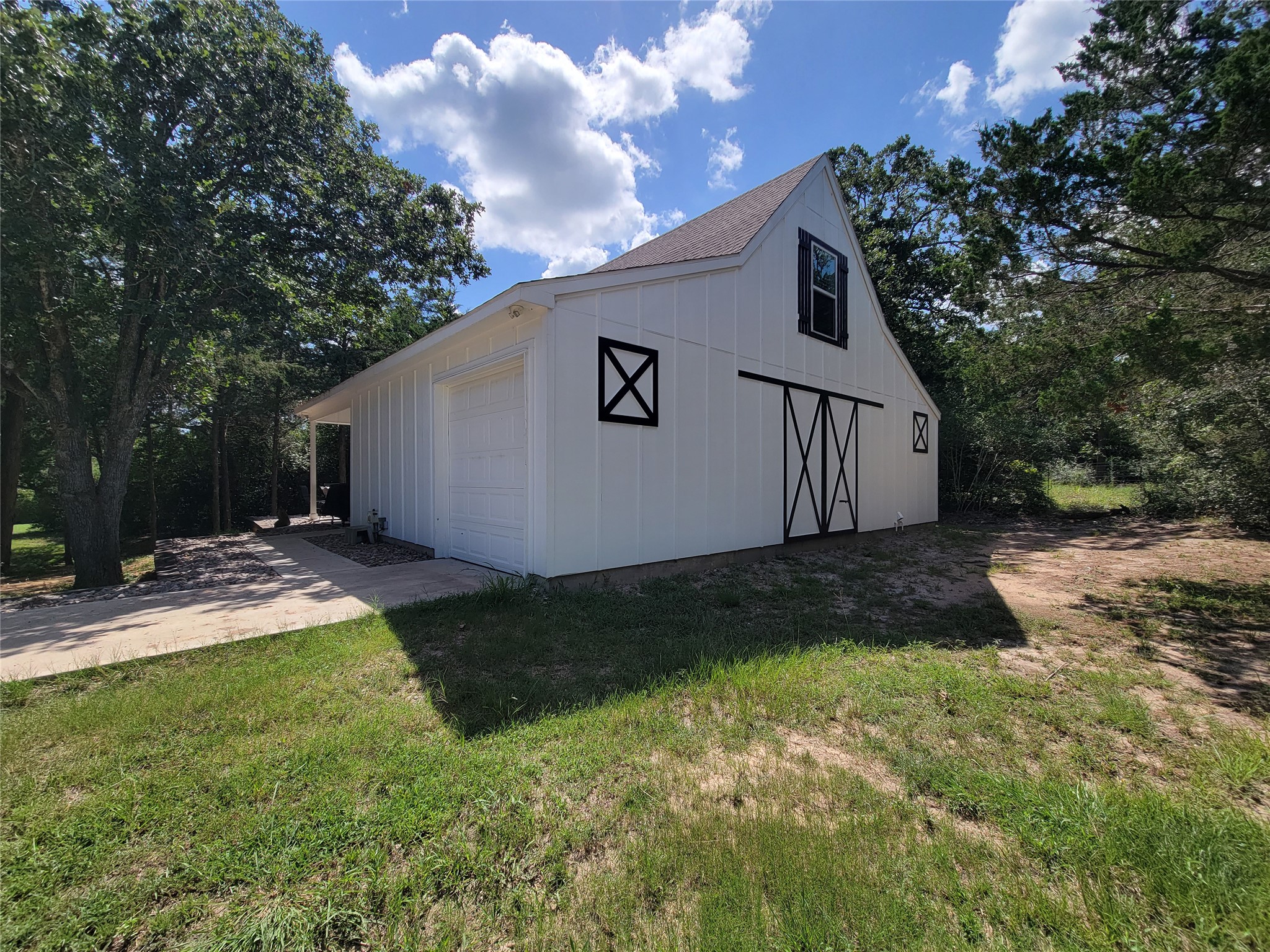 4937 Wolff Road Round Top, TX 78954 - Photo 4 of 31 Charming driveway leads to a single-car garage and inviting front entrance.