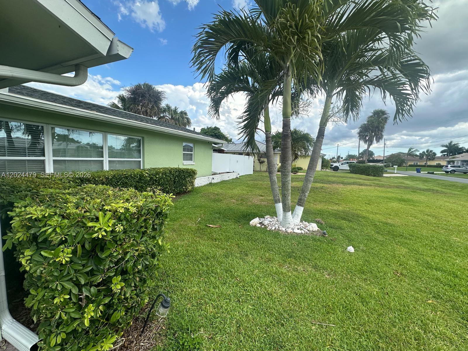 2212 Club House Road North Fort Myers, FL 33917 - Photo 2 of 40 a front view of a house with garden