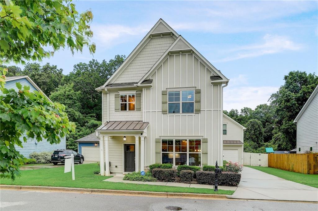 2676 Tilson Road Decatur, GA 30032 - Photo 1 of 1 a front view of a house with a yard and potted plants