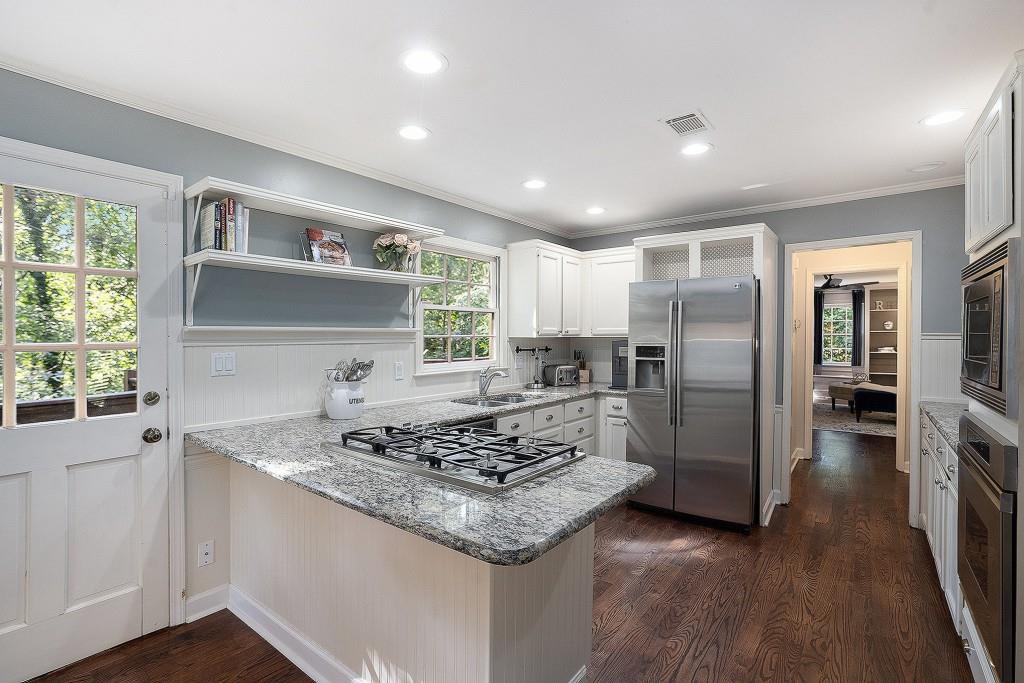 4682 Bentley Place Peachtree Corners, GA 30096 - Photo 15 of 44 a kitchen with stainless steel appliances granite countertop a sink stove and refrigerator