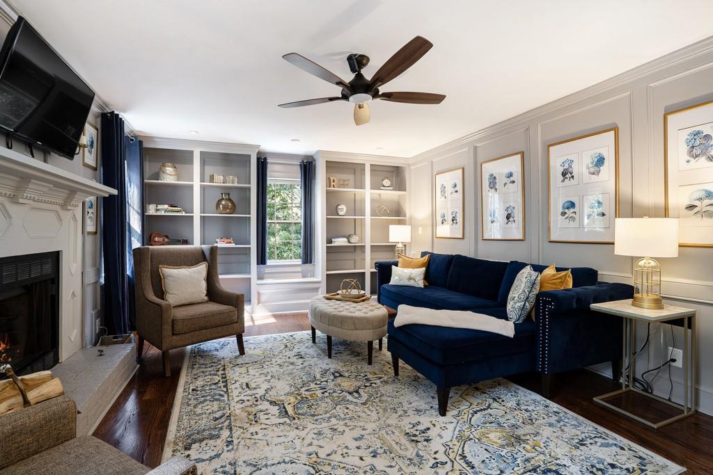 4682 Bentley Place Peachtree Corners, GA 30096 - Photo 19 of 44 a living room with furniture a flat screen tv and a fireplace