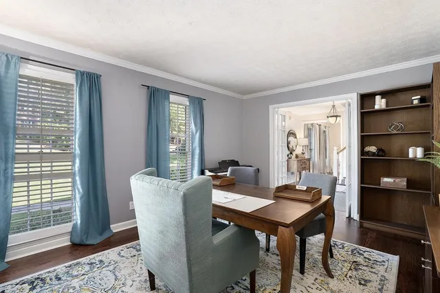 a room with furniture pool table and window