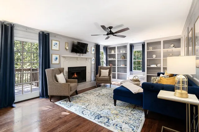 a living room with furniture fireplace and a flat screen tv