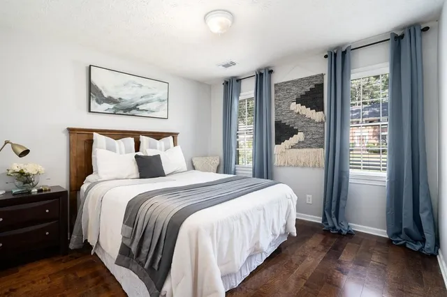 a bedroom with a bed and a painting on the wall