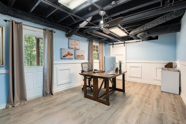 a workspace with furniture window and wooden floor