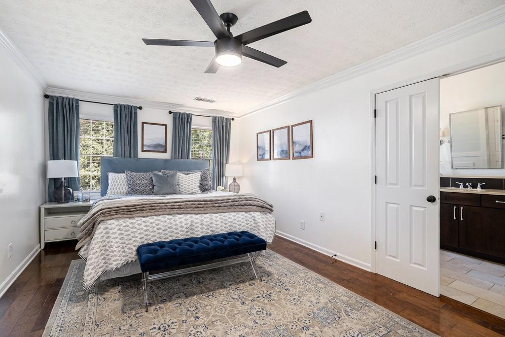 4682 Bentley Place Peachtree Corners, GA 30096 - Photo 4 of 44 a bedroom with a bed and a chandelier