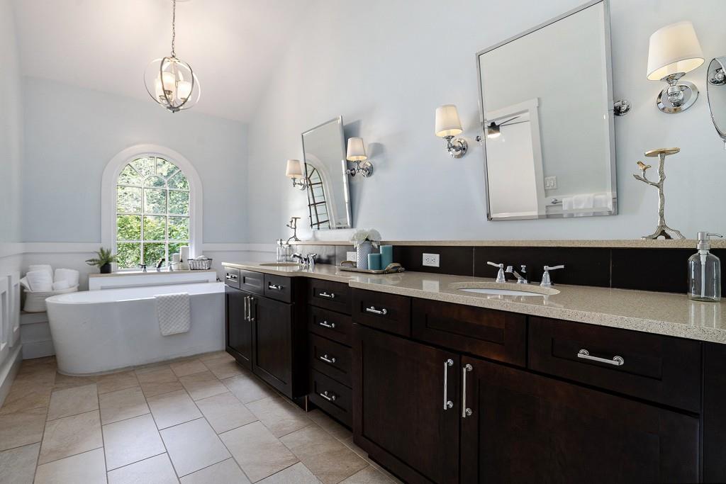 4682 Bentley Place Peachtree Corners, GA 30096 - Photo 5 of 44 a bathroom with a tub sink and mirror