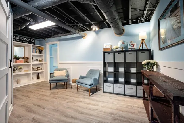a view of roof deck with wooden floor and seating space