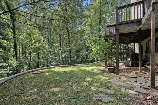 a aerial view of a brick house next to a yard