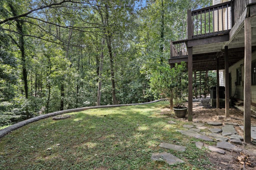 4682 Bentley Place Peachtree Corners, GA 30096 - Photo 8 of 44 a backyard of a house with lots of green space