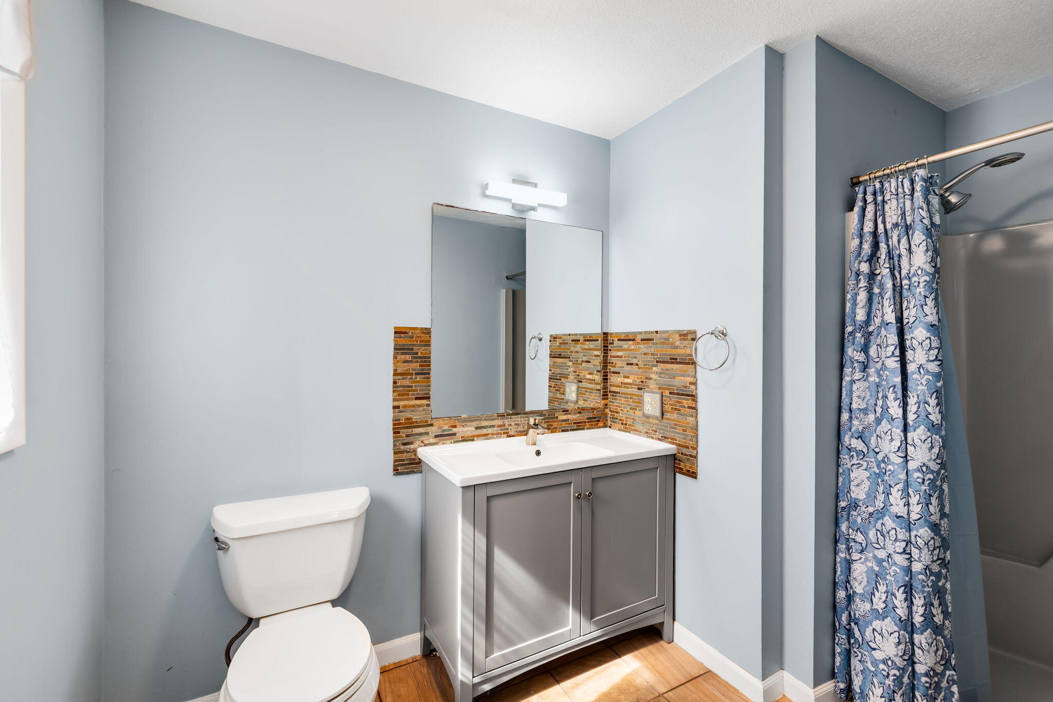21 Braeside Road Falmouth, MA 02540 - Photo 21 of 43 a bathroom with a granite countertop toilet sink and mirror