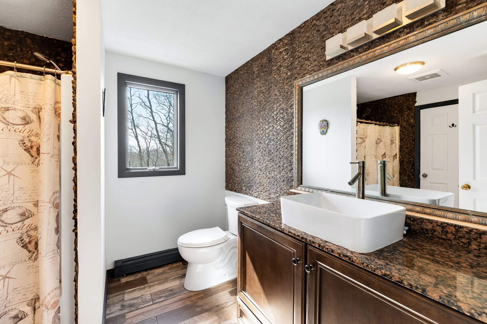 21 Braeside Road Falmouth, MA 02540 - Photo 28 of 43 a spacious bathroom with a granite countertop toilet a sink and a mirror