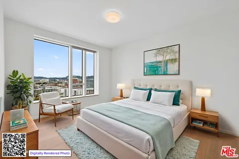 a bedroom with a bed a couch and a window