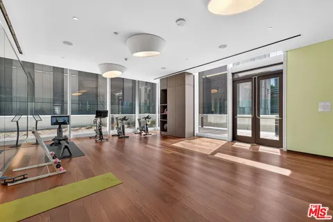 a view of a gym with large windows and wooden floor