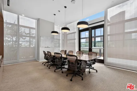 a view of a big room with furniture and windows
