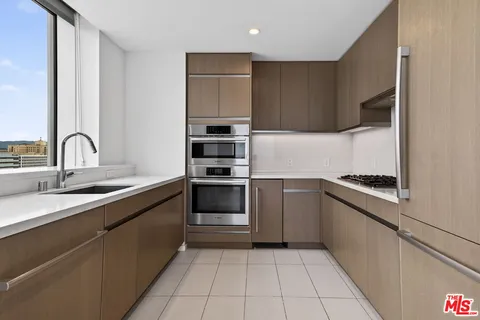 a kitchen with a sink and a stove top oven