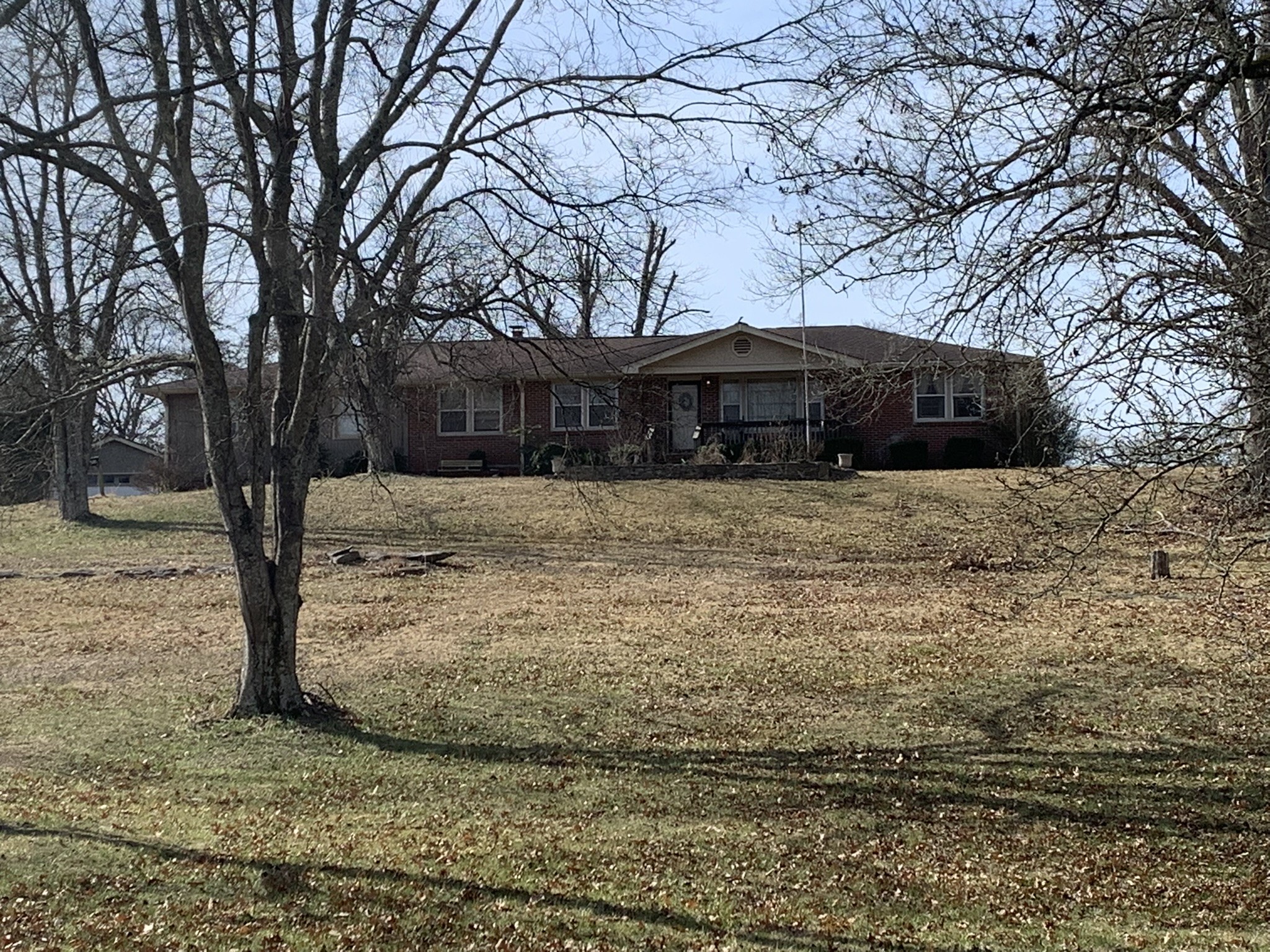 454 Canoe Branch Road Castalian Springs, TN 37031 - Photo 39 of 40 a view of a house with a yard covered with snow in the background