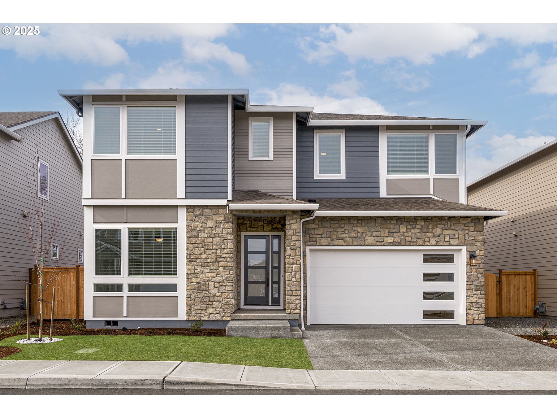 a front view of a house with a yard and garage