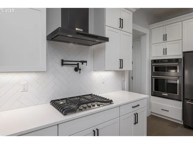 a kitchen with stainless steel appliances a stove and a refrigerator