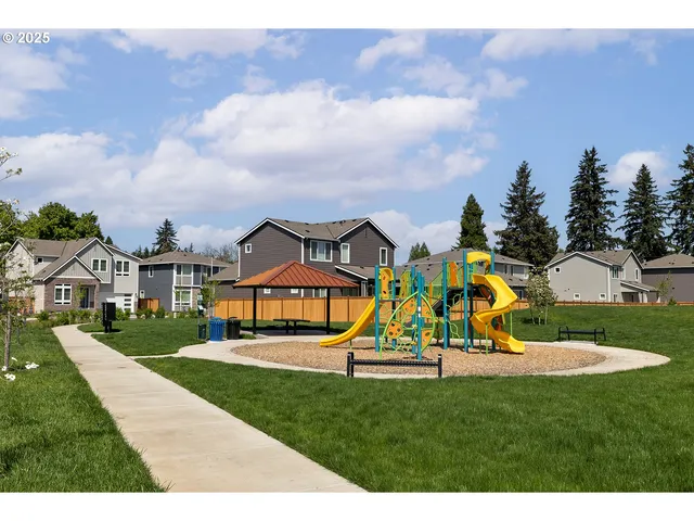 a view of a park with swings and slides