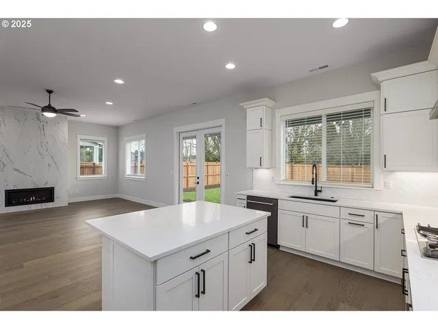 a kitchen with counter top space sink and center