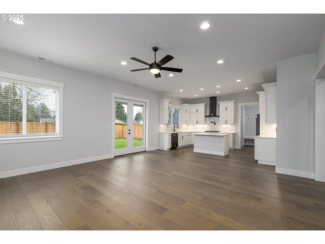 a view of a living room a window and a ceiling fan