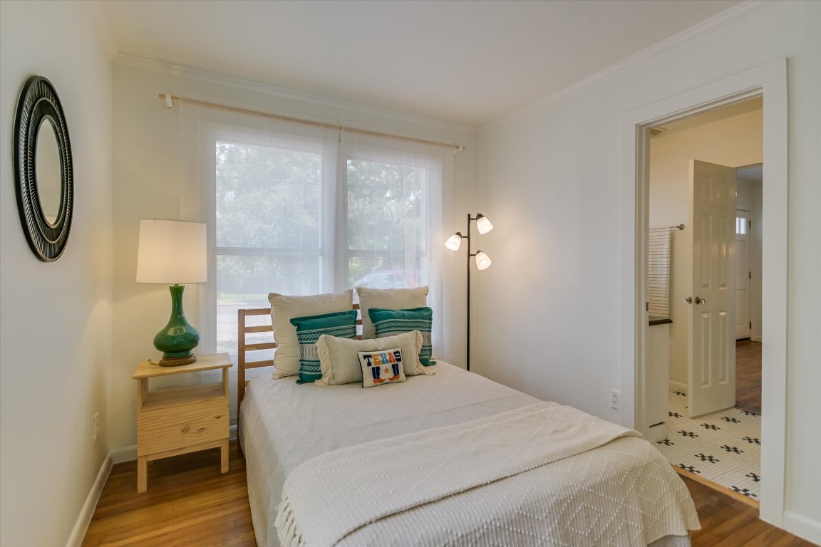 1110 West 22nd Street, Unit 16 Austin, TX 78705 - Photo 13 of 21 a bedroom with a bed a table and painting on the wall