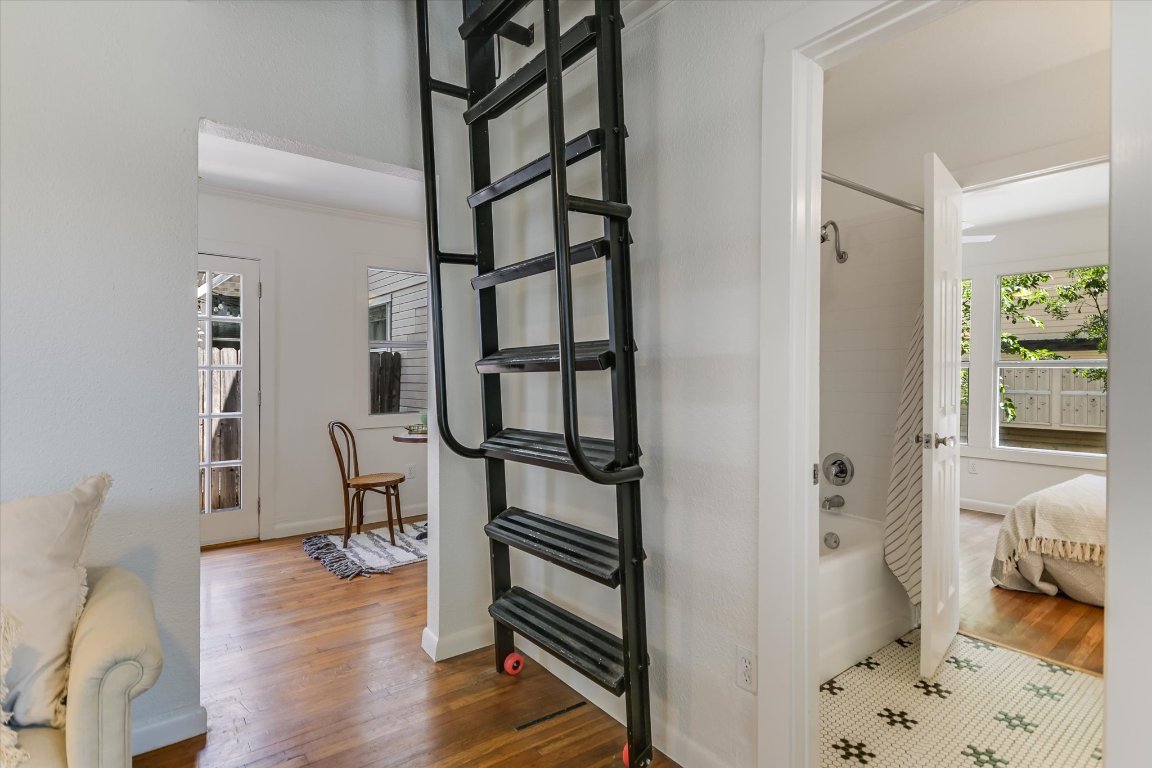 1110 West 22nd Street, Unit 16 Austin, TX 78705 - Photo 16 of 21 a view of a bedroom with furniture and wooden floor